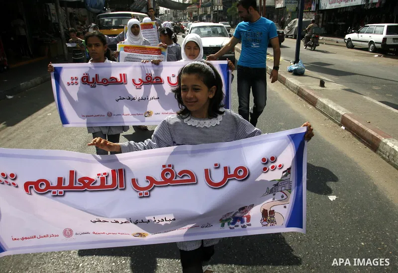Palestinian students participate in a rally during a campaign to defend their rights in Rafah, in the southern Gaza Strip, Sep. 11, 2012. Photo by Eyad Al Baba