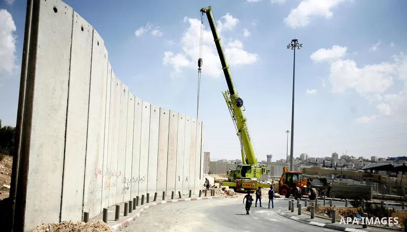 Israeli bulldozers work on the separation barrier in Shu'fat refugee camp in Jerusalem, September 11, 2012. Photo by Mahfouz Abu Turk