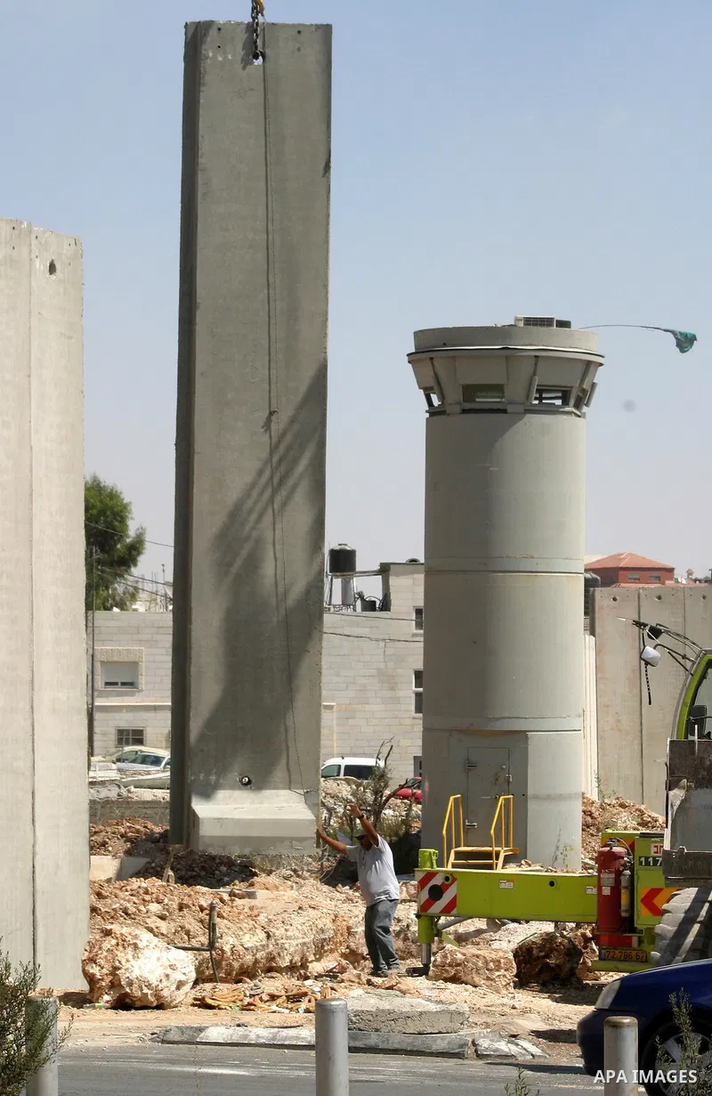Israeli bulldozers work on the separation barrier in Shu'fat refugee camp in Jerusalem, September 11, 2012. Photo by Mahfouz Abu Turk