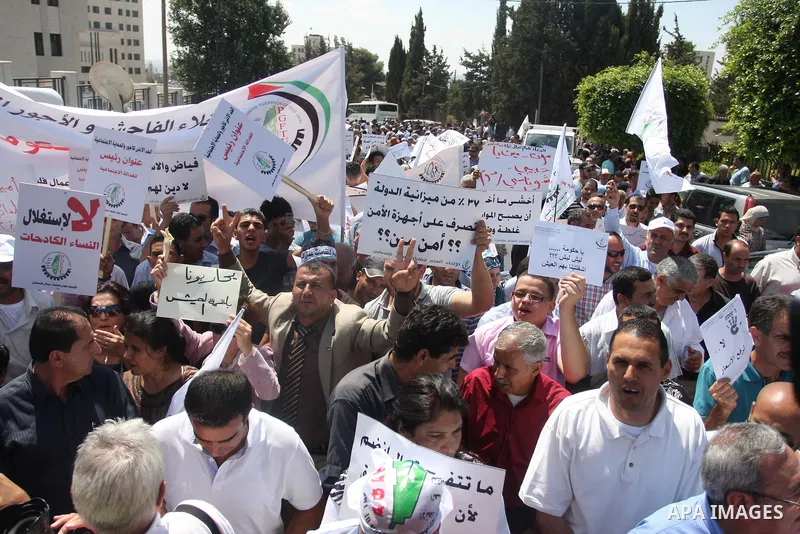 Palestinian protesters shout slogans during a demonstration against the high cost of living in the West Bank city of Ramallah, Sept. 11, 2012. The prime minister pledged on Tuesday that the Palestinian Authority will dec...