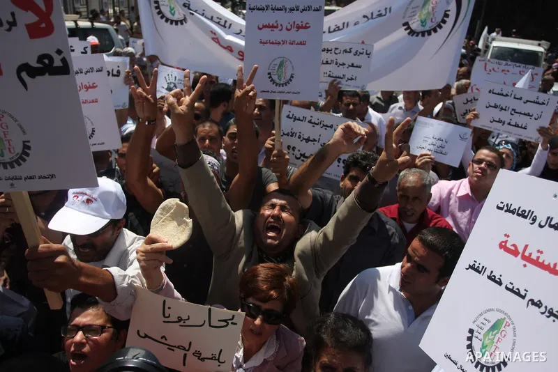 Palestinian protesters shout slogans during a demonstration against the high cost of living in the West Bank city of Ramallah, Sept. 11, 2012. The prime minister pledged on Tuesday that the Palestinian Authority will dec...