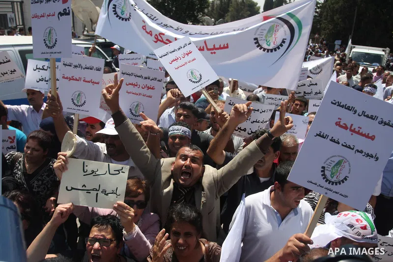 Palestinian protesters shout slogans during a demonstration against the high cost of living in the West Bank city of Ramallah, Sept. 11, 2012. The prime minister pledged on Tuesday that the Palestinian Authority will dec...
