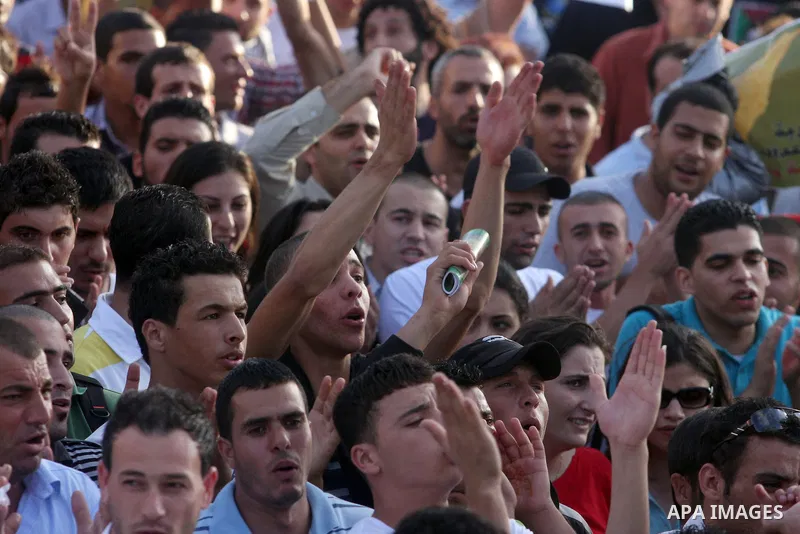 Palestinians shout slogans during a protest against the Paris Protocol and the Oslo Agreement, both key accords which govern economic ties between Palestinians and Israelis, in the West Bank city of Ramallah on September...