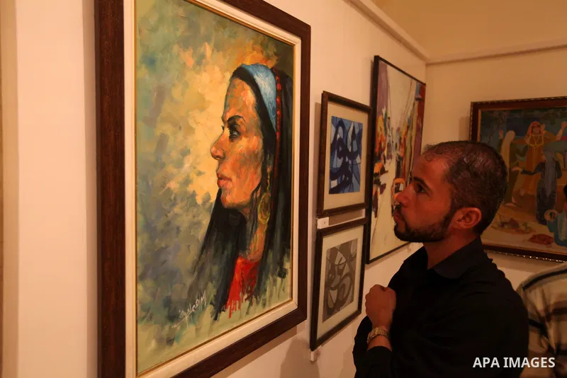 Palestinians attend an exhibition of plastic art at Movenpick Hotel in Gaza City on Sep. 11, 2012. Photo by Majdi Fathi