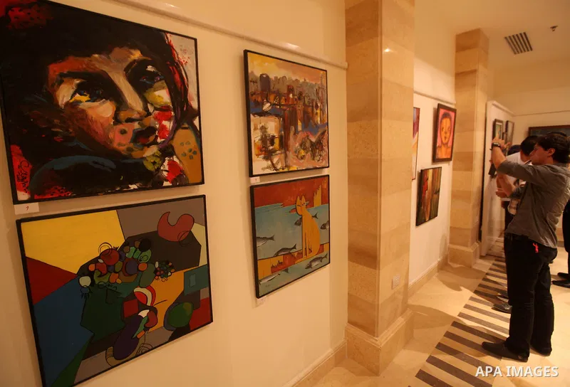 Palestinians attend an exhibition of plastic art at Movenpick Hotel in Gaza City on Sep. 11, 2012. Photo by Majdi Fathi