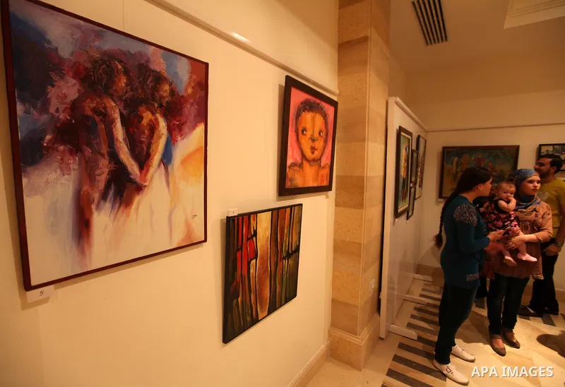 Palestinians attend an exhibition of plastic art at Movenpick Hotel in Gaza City on Sep. 11, 2012. Photo by Majdi Fathi