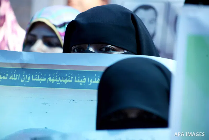 Palestinian women hold a placard depicting jailed relatives during a protest in Gaza City calling for the release of Palestinian prisoners from Israeli jails September 12 2012. Photo by Ashraf Amra