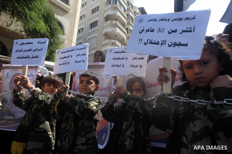 Palestinian children hold a placard depicting jailed relatives during a protest in Gaza City calling for the release of Palestinian prisoners from Israeli jails September 12 2012. Photo by Ashraf Amra