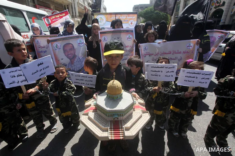 Palestinian children hold a placard depicting jailed relatives during a protest in Gaza City calling for the release of Palestinian prisoners from Israeli jails September 12 2012. Photo by Ashraf Amra