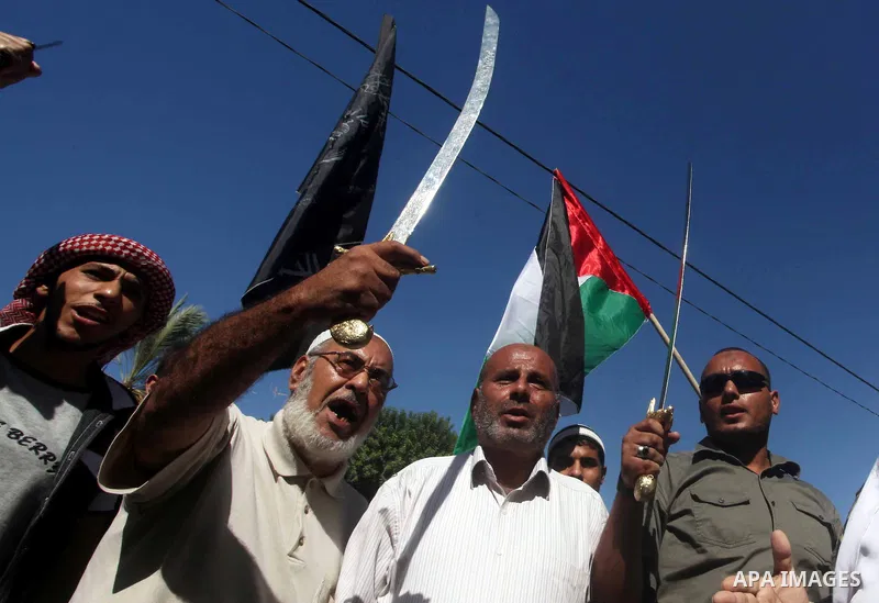 Palestinians hold swords and knifes during protest in front of the United Nations headquarters in Gaza city against the showing of a movie that is allegedly offensive to Muslim Prophet Mohammad, Sept 12, 2012. Photo by A...