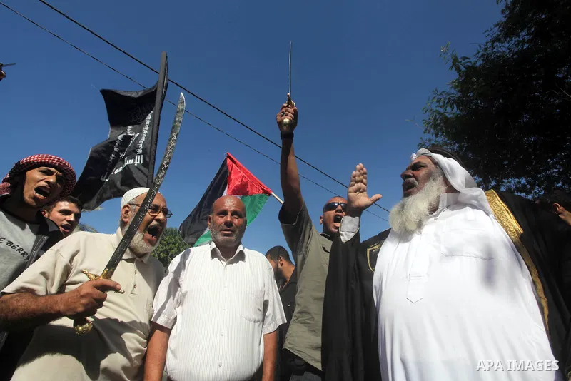 Palestinians hold swords and knifes during protest in front of the United Nations headquarters in Gaza city against the showing of a movie that is allegedly offensive to Muslim Prophet Mohammad, Sept 12, 2012. Photo by A...