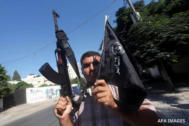 A Palestinian man hold AK47 weapon during protest in front of the United Nations headquarters in Gaza city against the showing of a movie that is allegedly offensive to Muslim Prophet Mohammad, Sept 12, 2012. Photo by As...