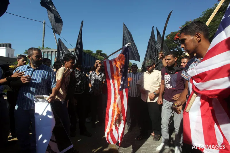 Palestinians burn the U.S. flag during a protest in front of the United Nations headquarters in Gaza city against the showing of a movie that is allegedly offensive to Muslim Prophet Mohammad, Sept 12, 2012. Photo by Ash...