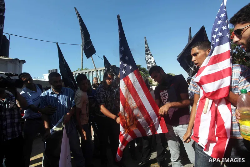 Palestinians burn the U.S. flag during a protest in front of the United Nations headquarters in Gaza city against the showing of a movie that is allegedly offensive to Muslim Prophet Mohammad, Sept 12, 2012. Photo by Ash...
