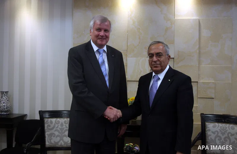 Palestinian Prime Minister Salam Fayyad, right, shakes hands with visiting Bavarian Prime Minister Horst Seehofer during a meeting in the West Bank city of Ramallah, Sept. 11, 2012. Photo by Issam Rimawi