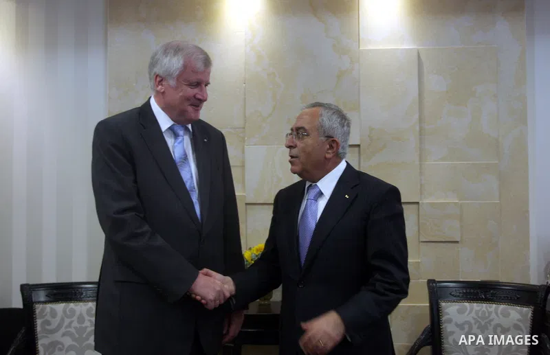 Palestinian Prime Minister Salam Fayyad, right, shakes hands with visiting Bavarian Prime Minister Horst Seehofer during a meeting in the West Bank city of Ramallah, Sept. 11, 2012. Photo by Issam Rimawi