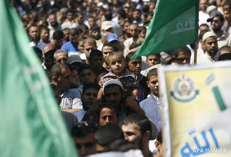 Palestinians hold placards as they shout anti-U.S. slogans during a demonstration against the controversial film 'Innocence of Muslims' in Rafah southern Gaza strip, on September 14, 2012. The controversial low budget fi...