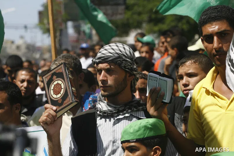 Palestinians hold placards as they shout anti-U.S. slogans during a demonstration against the controversial film 'Innocence of Muslims' in Rafah southern Gaza strip, on September 14, 2012. The controversial low budget fi...
