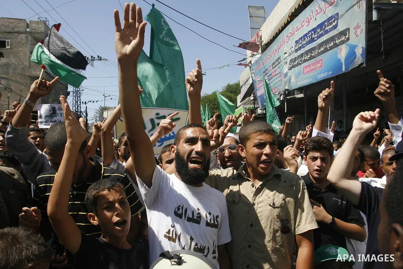 Palestinians hold placards as they shout anti-U.S. slogans during a demonstration against the controversial film 'Innocence of Muslims' in Rafah southern Gaza strip, on September 14, 2012. The controversial low budget fi...