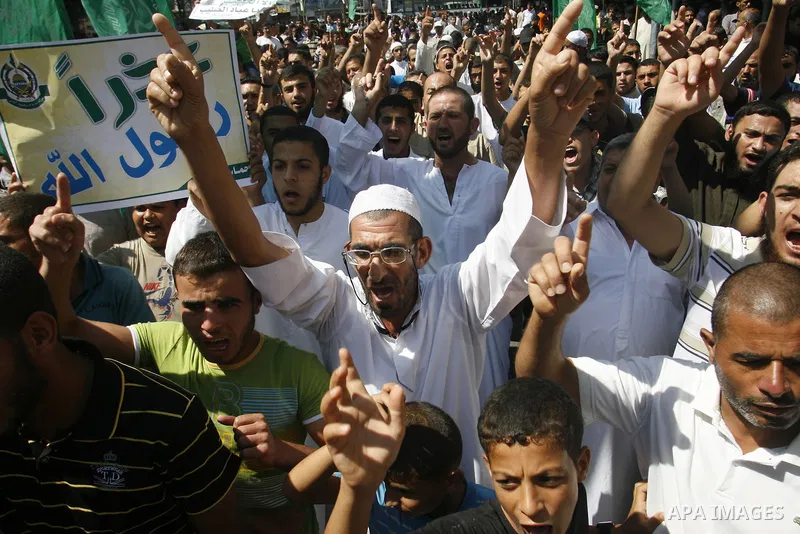 Palestinians hold placards as they shout anti-U.S. slogans during a demonstration against the controversial film 'Innocence of Muslims' in Rafah southern Gaza strip, on September 14, 2012. The controversial low budget fi...