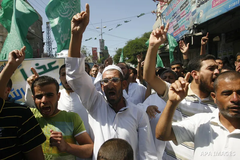 Palestinians hold placards as they shout anti-U.S. slogans during a demonstration against the controversial film 'Innocence of Muslims' in Rafah southern Gaza strip, on September 14, 2012. The controversial low budget fi...