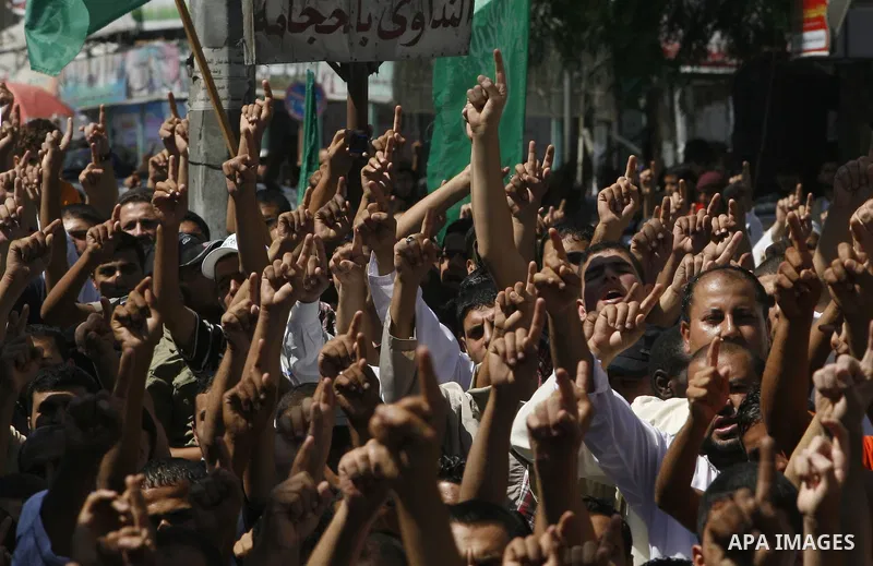 Palestinians hold placards as they shout anti-U.S. slogans during a demonstration against the controversial film 'Innocence of Muslims' in Rafah southern Gaza strip, on September 14, 2012. The controversial low budget fi...