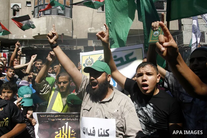 Palestinians hold placards as they shout anti-U.S. slogans during a demonstration against the controversial film 'Innocence of Muslims' in Rafah southern Gaza strip, on September 14, 2012. The controversial low budget fi...