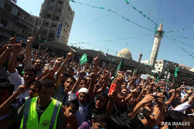 Palestinians hold placards as they shout anti-U.S. slogans during a demonstration against the controversial film 'Innocence of Muslims' in Khan Younis southern Gaza strip, on September 14, 2012. The controversial low bud...