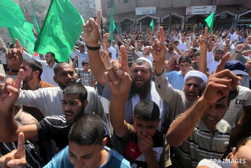 Palestinians hold placards as they shout anti-U.S. slogans during a demonstration against the controversial film 'Innocence of Muslims' in Khan Younis southern Gaza strip, on September 14, 2012. The controversial low bud...