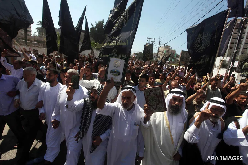 Palestinians hold placards as they shout anti-U.S. slogans during a demonstration against the controversial film 'Innocence of Muslims' in Khan Younis southern Gaza strip, on September 14, 2012. The controversial low bud...