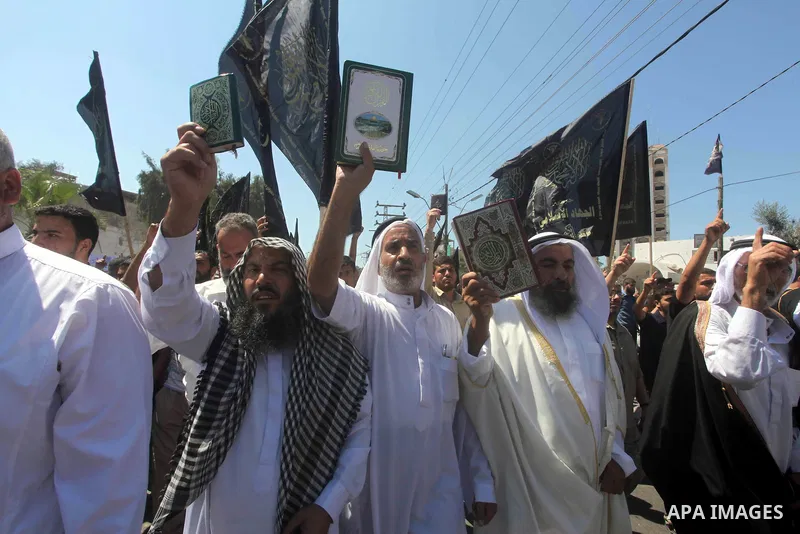 Palestinians hold placards as they shout anti-U.S. slogans during a demonstration against the controversial film 'Innocence of Muslims' in Khan Younis southern Gaza strip, on September 14, 2012. The controversial low bud...