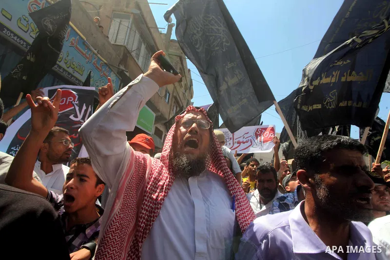 Palestinians hold placards as they shout anti-U.S. slogans during a demonstration against the controversial film 'Innocence of Muslims' in Khan Younis southern Gaza strip, on September 14, 2012. The controversial low bud...