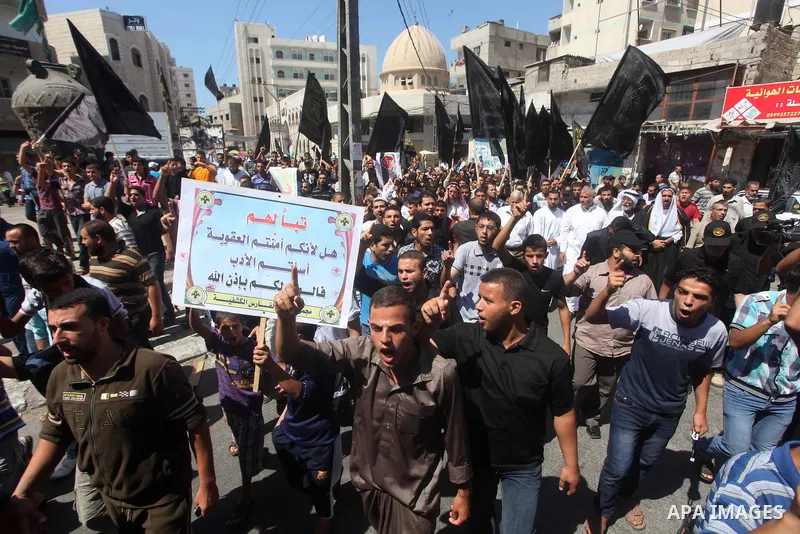 Palestinians hold placards as they shout anti-U.S. slogans during a demonstration against the controversial film 'Innocence of Muslims' in Khan Younis southern Gaza strip, on September 14, 2012. The controversial low bud...