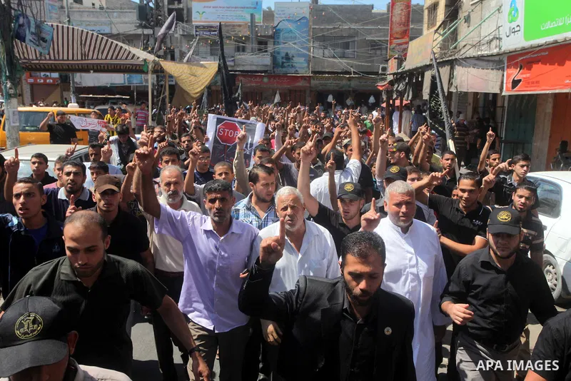 Palestinians hold placards as they shout anti-U.S. slogans during a demonstration against the controversial film 'Innocence of Muslims' in Khan Younis southern Gaza strip, on September 14, 2012. The controversial low bud...