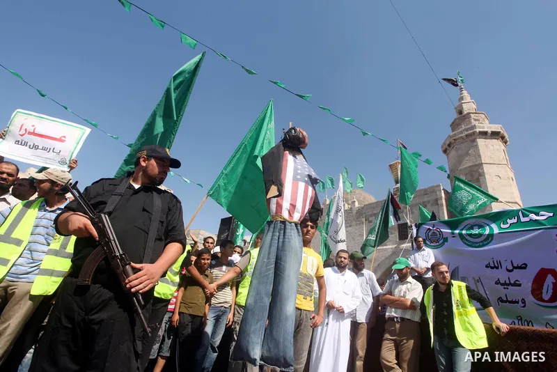 Palestinians hold placards as they shout anti-U.S. slogans during a demonstration against the controversial film 'Innocence of Muslims' in Khan Younis southern Gaza strip, on September 14, 2012. The controversial low bud...