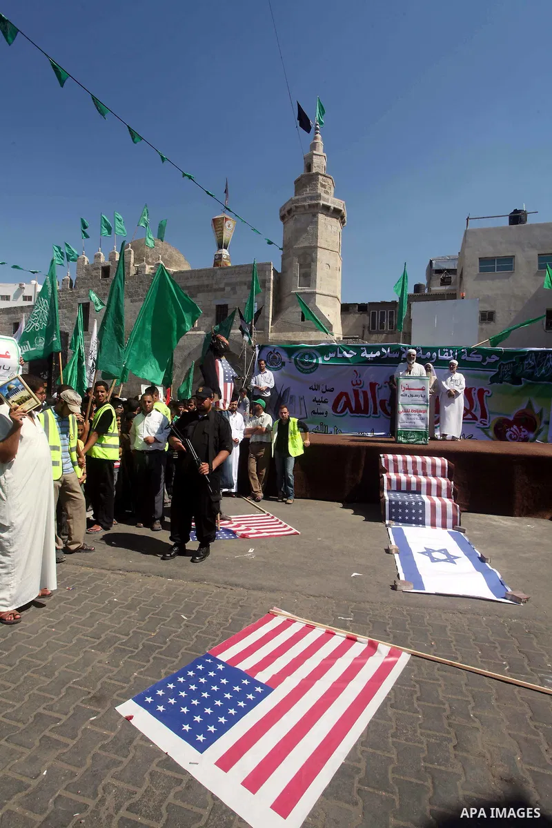Palestinians walk on the U.S. flag during a demonstration against the controversial film 'Innocence of Muslims' in Khan Younis southern Gaza strip, on September 14, 2012. The controversial low budget film reportedly made...