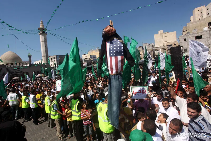 Palestinians hold placards as they shout anti-U.S. slogans during a demonstration against the controversial film 'Innocence of Muslims' in Khan Younis southern Gaza strip, on September 14, 2012. The controversial low bud...