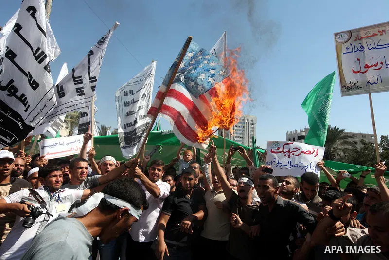 Palestinians burn the U.S. flags during a demonstration against the controversial film 'Innocence of Muslims' in Gaza city, on September 14, 2012. The controversial low budget film reportedly made by an Israeli-American...