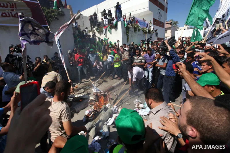 Palestinians burn the U.S. flags during a demonstration against the controversial film 'Innocence of Muslims' in Gaza city, on September 14, 2012. The controversial low budget film reportedly made by an Israeli-American...