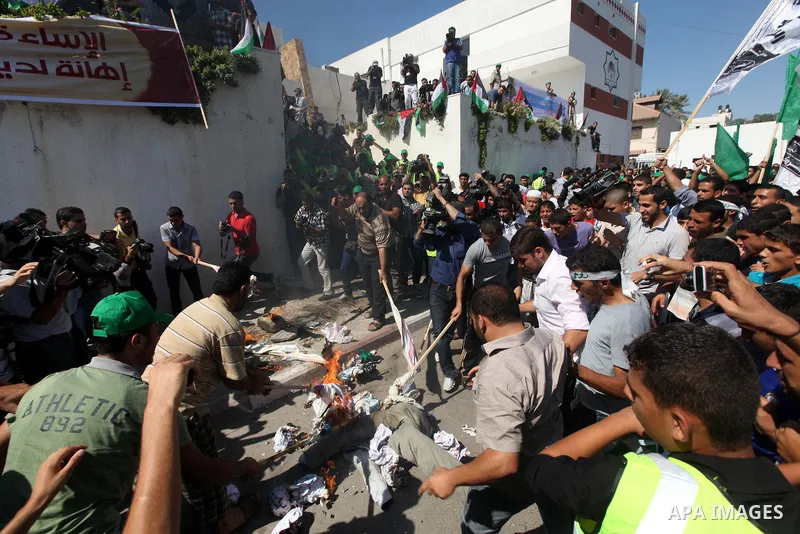 Palestinians burn the U.S. flags during a demonstration against the controversial film 'Innocence of Muslims' in Gaza city, on September 14, 2012. The controversial low budget film reportedly made by an Israeli-American...