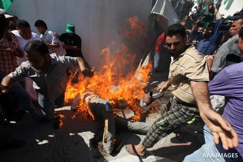 Palestinians burn the U.S. flags during a demonstration against the controversial film 'Innocence of Muslims' in Gaza city, on September 14, 2012. The controversial low budget film reportedly made by an Israeli-American...