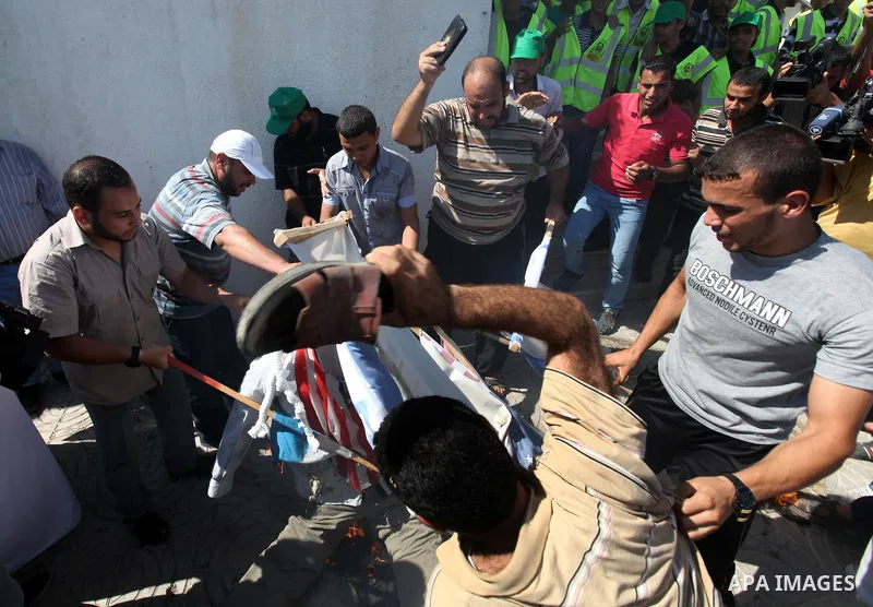 Palestinians burn the U.S. flags during a demonstration against the controversial film 'Innocence of Muslims' in Gaza city, on September 14, 2012. The controversial low budget film reportedly made by an Israeli-American...