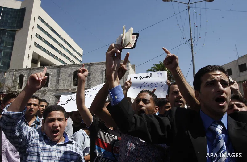 A Palestinian holds up a copy of the Quran during a demonstration against the controversial film 'Innocence of Muslims' in the West Bank city of Nablus, on September 14, 2012. The controversial low budget film reportedly...