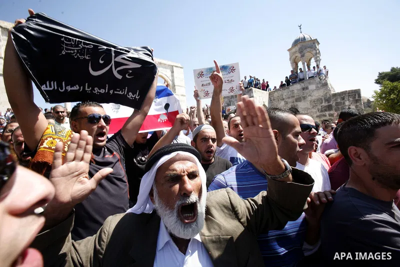 Palestinians shout slogans during a demonstration against the controversial film 'Innocence of Muslims' in front of al-Aqsa Mosqe in Jerusalem, on September 14, 2012. The controversial low budget film reportedly made by...