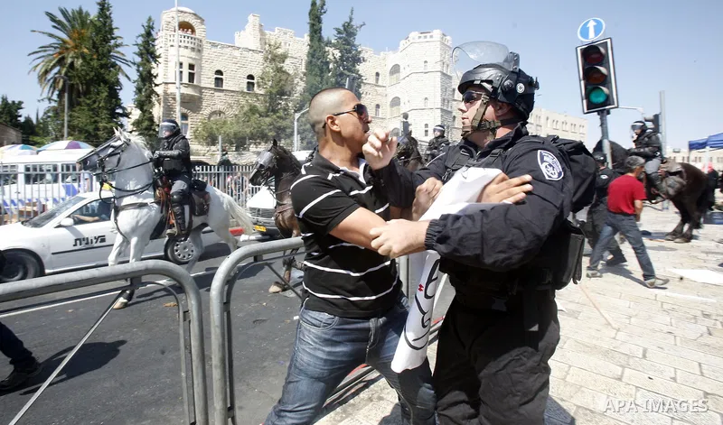 Israeli policeman clashes with a Palestinian protester during a demonstration against the controversial film 'Innocence of Muslims' in front of al-Aqsa Mosqe in Jerusalem, on September 14, 2012. The controversial low bud...