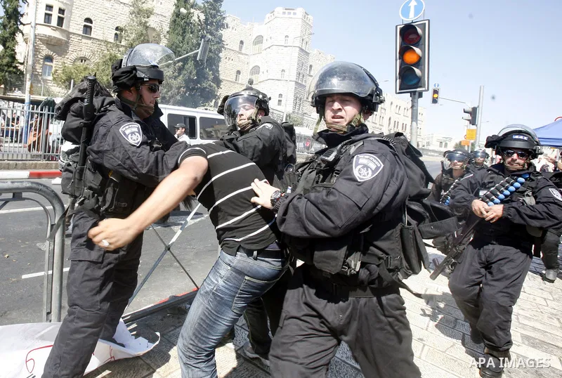 Israeli policemen detain a Palestinian protester during a demonstration against the controversial film 'Innocence of Muslims' in front of al-Aqsa Mosqe in Jerusalem, on September 14, 2012. The controversial low budget fi...