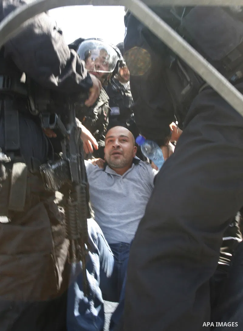 Israeli policemen detain a Palestinian protester during a demonstration against the controversial film 'Innocence of Muslims' in front of al-Aqsa Mosqe in Jerusalem, on September 14, 2012. The controversial low budget fi...