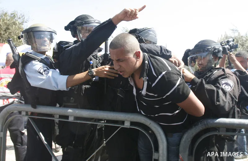 Israeli policemen detain a Palestinian protester during a demonstration against the controversial film 'Innocence of Muslims' in front of al-Aqsa Mosqe in Jerusalem, on September 14, 2012. The controversial low budget fi...