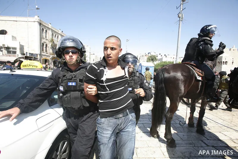 Israeli policemen detain a Palestinian protester during a demonstration against the controversial film 'Innocence of Muslims' in front of al-Aqsa Mosqe in Jerusalem, on September 14, 2012. The controversial low budget fi...