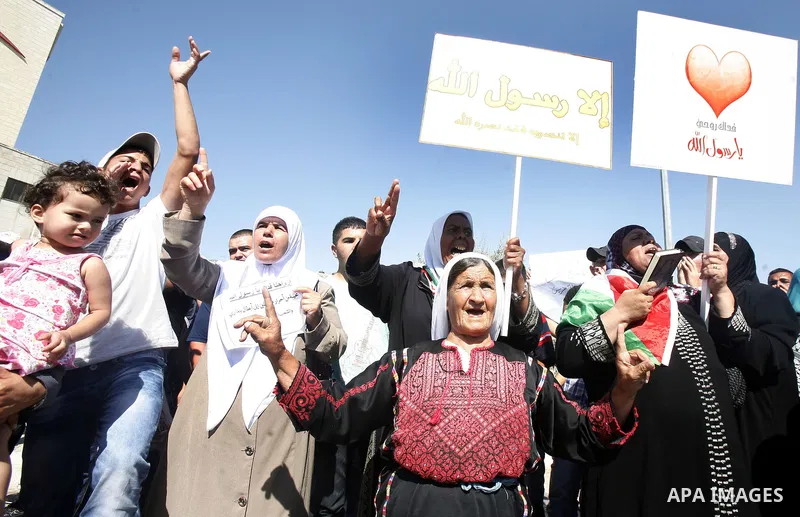 Palestinians shout slogans during a demonstration against the controversial film 'Innocence of Muslims' in front of al-Aqsa Mosqe in Jerusalem, on September 14, 2012. The controversial low budget film reportedly made by...